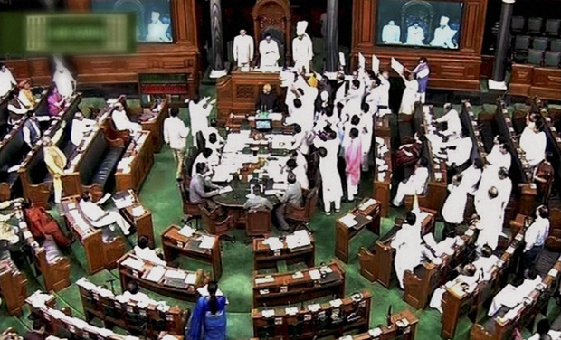 Opposition members protest in the well of the Lok Sabha in New Delhi on Wednesday during the monsoon session. (Photo: PTI) Opposition members protest in the well of the Lok Sabha in New Delhi on Wednesday during the monsoon session. (Photo: PTI)